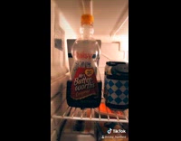 Guy checks out bottle of Mrs butterworth syrup