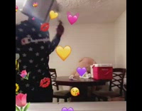 Guy wears metal pot on his head, uses spoon and spatula as drumsticks, and plays the drums to beat of song