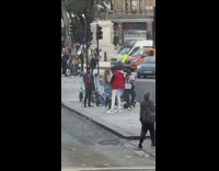 Man and Woman dances in a music video shoot in the street