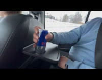 Man places energy can in car holder