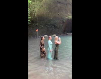 Three girls long dresses in water waterfall 