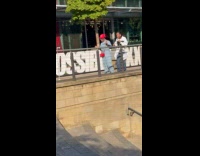 Two women dances beside railings near stairs