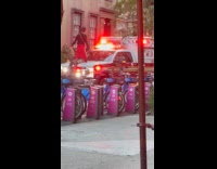 Man kneeling on ambulance hood 