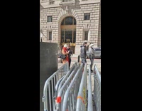 People line up to take pictures with metal bull