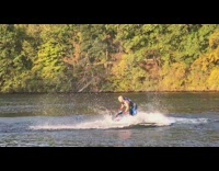 Man blue jet ski backflip and spin combo on lake water
