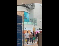 Two women dance tiktok video mall balcony