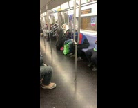 Person in Cat Mask Tucks Phone in Jacket