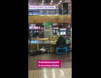 A man asleep next to colorful piano