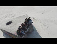 Friends sit over old WW2 bunker beach