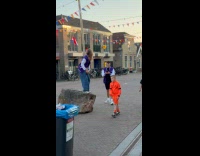 Woman bends butt to tower at street