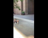 Collab WINY - Guy white shirt lays on his side on the pavement for a photo