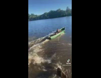 Collab BitchMP - Guys in green canoe slide down grass hill into lake 