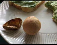 Avocado pit seed on the plate next to the bread