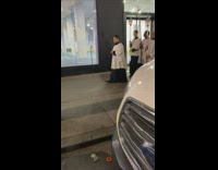 Religious group walk down sidewalk with torches and chant prayer