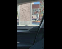 Lady in Cow Print Poses for Photoshoot near Artwork 