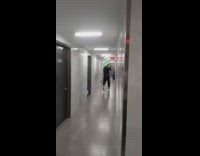 Guy runs away with green inflatable alien 