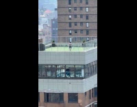 Shirtless man dance jog in place rooftop