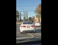 White car Jaguar logo plate INFLNCR road sunset