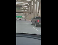 Man on one wheel motorcycle on freeway