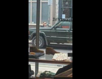 Woman in black coat poses at the sidewalk