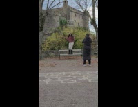 Woman in maroon top throw leaves for a tiktok dance