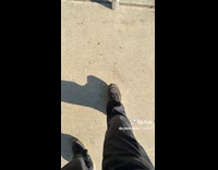 Man crushes soda cans by stepping on them on street