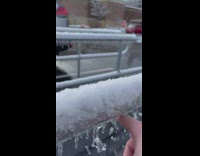 Guy breaks all frozen water icicles on cart stall