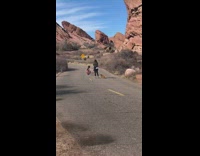 Woman with small dog posing in canyon road