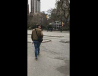 Man in tophat, blue and gold cloak rides around in a scooter and blasts music on a speaker