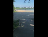Lady in blue dress dances in front of memorial 