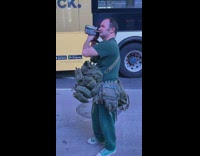Man with handheld recorder and bags