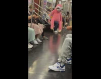 Life sized stuffed toy sit at the train inside with passengers