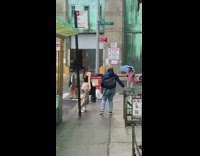 Two people shake their butts at passing bus of convicts