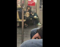 Guy eats from a small pot on subway 