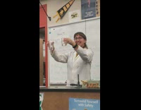 Professor performs experiment where one clear liquid turns black