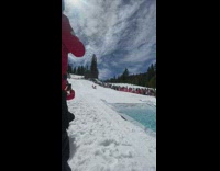 Skier and snowboarder go down hill in competition