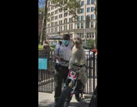 Dog and the officer takes photo from strangers at the park