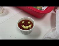 Ketchup in a cup with fries used as a smiley face