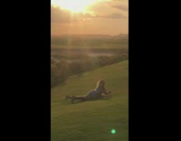 Woman white dress lay golf course sunset