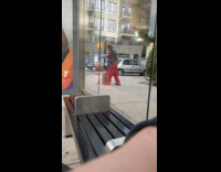 Man doing interpretive dance next to his luggage