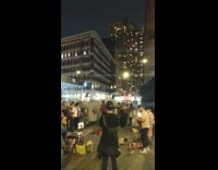 Band plays sidewalk people dance street costume