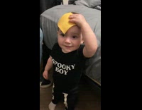 Cheese slice on boys head