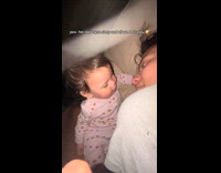 Mom and baby playing while dad sleeps 