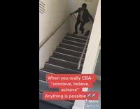 Grey jacket guy jumps over stairs 