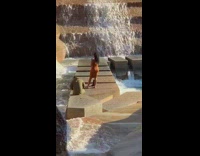 Lady takes selfies on stone walkway 