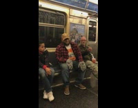 Guy red plaid shirt wears werewolf hands on subway train