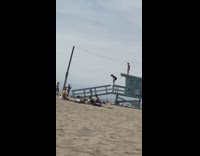 Two girls climb blue lifeguard tower dance 