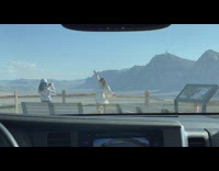 Girl dress raise peace sign overlooking mountain