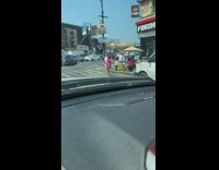 Lady dances while waiting to walk on crosswalk 