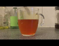 Turmeric in water changes color with lemon juice in the glass
